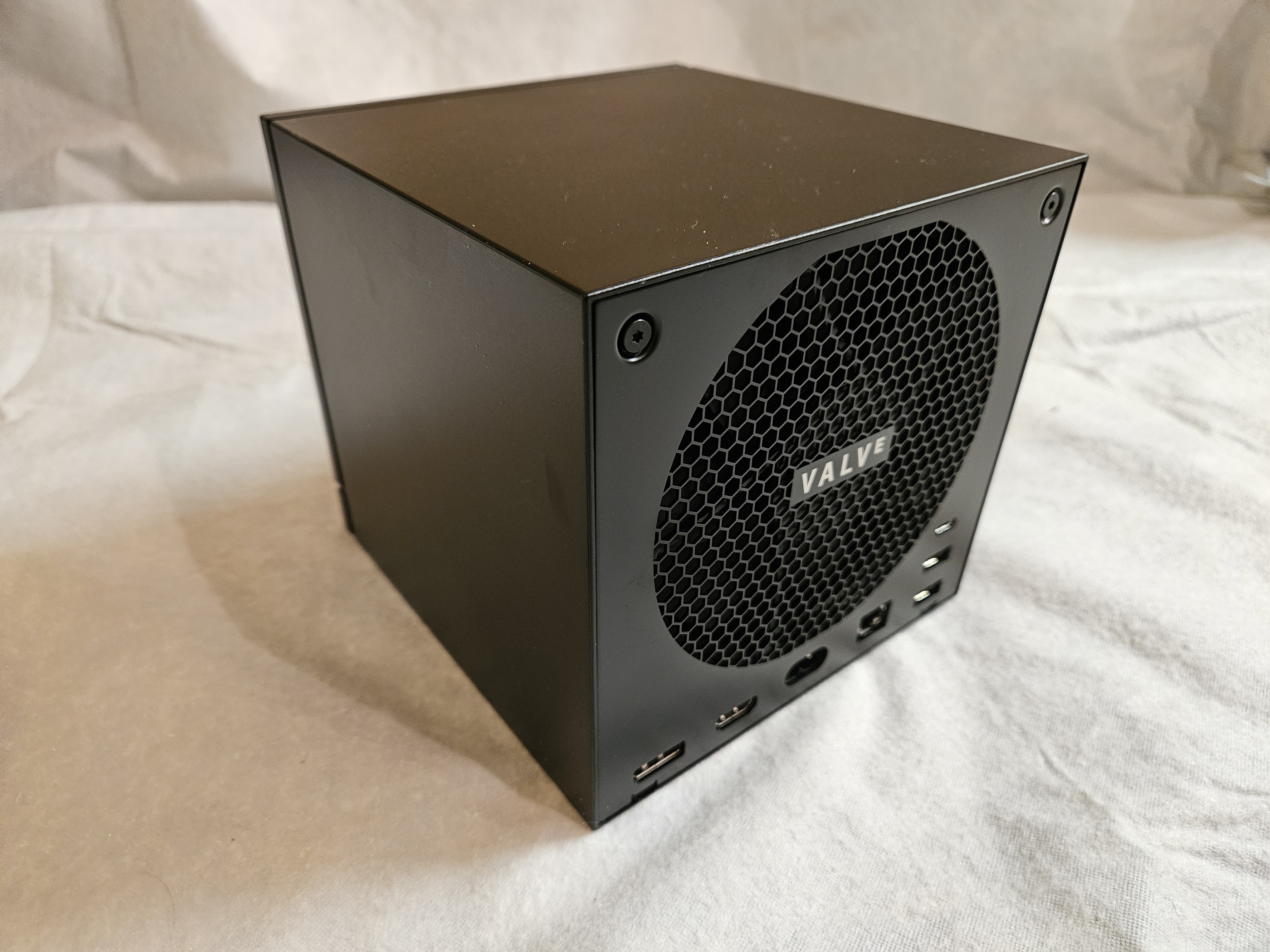 Valve Steam Machine rear panel with honeycomb vent, Valve badge, and I/O ports